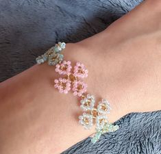 a woman's arm with bracelets made out of beads and glass beads on it