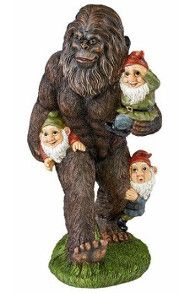 a statue of an old man and two gnomes