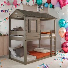 there is a bunk bed in the room with balloons and confetti all around