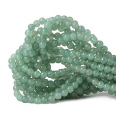 green jade beads on white background