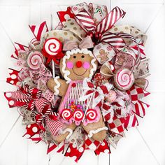 a wreath made out of candy canes and gingerbread cookies on a white background