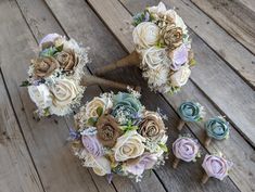 the bridal bouquets are arranged on the wooden floor