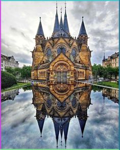 the reflection of an old building in water is shown on top of it's surface