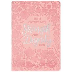 a pink notebook with the words, she is clothed with strength and beauty on it