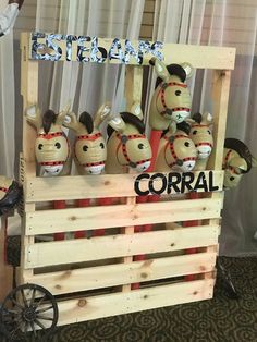 a wooden crate filled with stuffed animals sitting on top of a carpeted floor