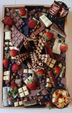 a box filled with assorted chocolates and strawberries