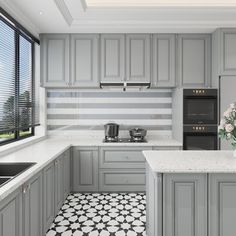 a kitchen with gray cabinets and white counter tops