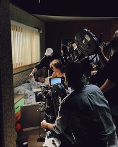 a group of people in a room with cameras