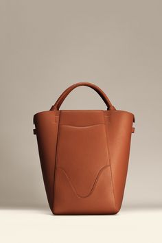 Experience modern simplicity with the Marina Bucket, embodying the dynamic spirit of city-living. Crafted from responsibly sourced Italian top grain leather, this sleek and lightweight bag complements any outfit. It features a central compartment that accommodates up to a 14" laptop, and can be worn as a handbag or shoulder bag. Plus, includes a detachable leather zip pouch for those spontaneous moments on-the-go. Work Bags For Women, Leather Zip Pouch, Leather Work Bag, Sustainable Leather, Laptop Tote, Lightweight Bag, Stylish Shoulder Bag, Leather Bucket Bag, Leather Bucket