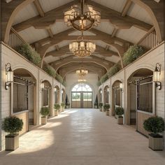 the inside of a large building with lots of windows and plants on either side of it