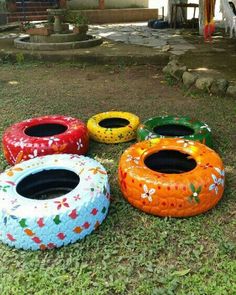 four painted tires sitting in the grass