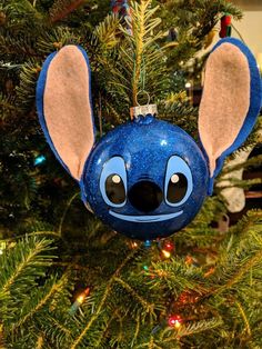 a blue ornament hanging from a christmas tree