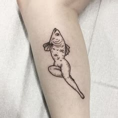 a small fish tattoo on the arm