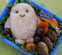 a bento box filled with rice, veggies and meatballs for halloween