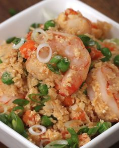 a white bowl filled with rice and shrimp