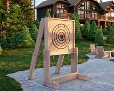 a wooden board with a target on it in front of a house