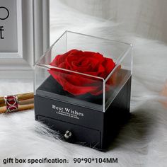 a red rose is in a clear box