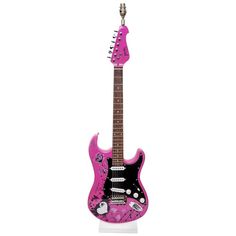 a pink guitar with black and white designs on the body, sitting in front of a white background