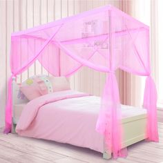 a pink canopy bed with curtains and pillows