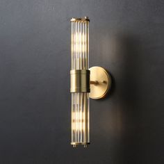 a wall light that is on the side of a wall with two lights in it