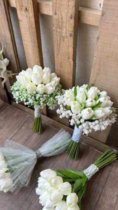 three bouquets of white tulips and other flowers