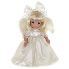 a doll with blonde hair wearing a white dress and angel wings on it's head