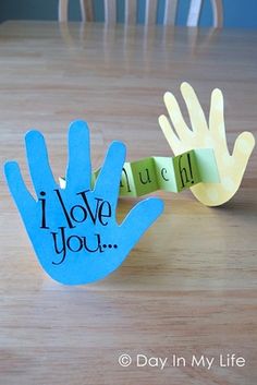 a hand made out of paper with the words i love you on it