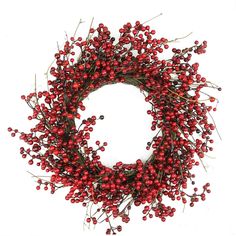 a wreath with red berries hanging from it