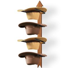 three hats are hanging on the wall and one has a hat rack attached to it