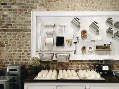 an open workshop is set up with pots and pans on the wall next to each other