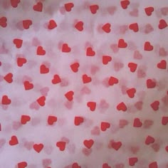 red hearts on white paper with pink background