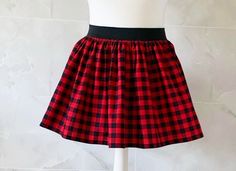 Mini Plaid / Check Skirt Gathered mini skirt made from a beautiful 100% cotton, red and black check fabric. Each skirt is made by gathering the fabric onto a 2 inch black elastic waistband. The length measures from the top of the waistband and comes in two lengths, 14" or 16". Please choose length from the drop down menu. The waist measurement can be seen in the measurement guide below. Please choose waist size from the drop down menu. For reference, the skirt pictured is size M and 14 inches lo Red Grunge Mini Skirt, Punk Plaid Skirt, Black Plaid Skirt, Retro Plaid Mini Skirt Bottoms, Goth Plaid Skirt, Red And Black Plaid Mini Skirt, Check Skirt, Attitude Clothing, Check Fabric