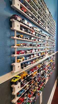 the wall is filled with many toy cars