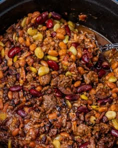 a pot filled with chili and beans on top of a stove