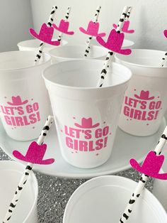 plastic cups with straws in the shape of cowboy hats and letters that say let's go girls