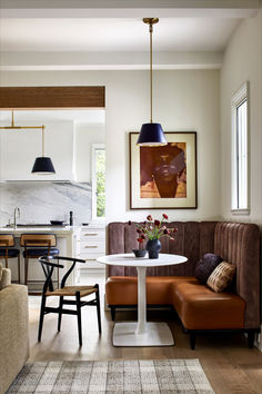 a living room filled with furniture and a white table