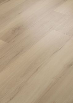 a white toilet sitting on top of a wooden floor