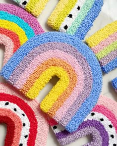 colorful crocheted letters and numbers are arranged on a white surface with polka dots