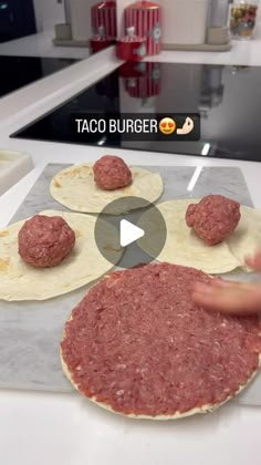 a person making hamburgers on top of a counter