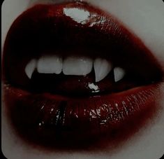 a woman's mouth with white teeth and red lipstick