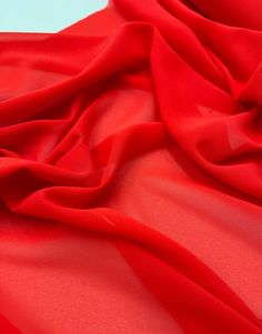 Add a touch of sophistication to your wardrobe or project with this soft Georgette chiffon fabric. With a width of 58 inches and a weight that is light, this fabric is perfect for a variety of uses such as creating beautiful dresses, loungewear, saris and even outdoor furniture or drapery. The material is suitable for everyday clothing, costumes, upholstery, crafts, and draping. This beautiful fabric is sold by the metre and is perfect for any project that requires a touch of elegance. With its Fitted Red Chiffon Dress, Formal Red Flowy Chiffon Dress, Formal Flowy Red Chiffon Dress, Red Silk Fabric, Red Unstitched Georgette Embroidered Fabric, Silk Fabric Red, Red Knit Fabric, Red Chiffon, Dress Crafts