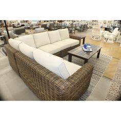 a wicker couch and coffee table in a store