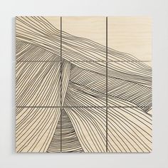 a piece of wood that has lines drawn on it and is in front of a white wall