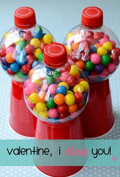 two red canisters filled with candy on top of a table