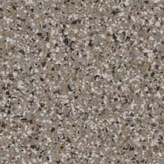 a brown and white speckled surface with small rocks on it's sides, as well as an area for text