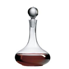 a glass decanter with a silver ball on the top and brown liquid in it