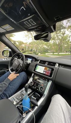 a man is driving in his car with the steering wheel and dashboard up to him