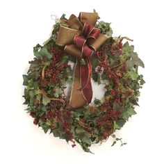 a christmas wreath with red berries and green leaves