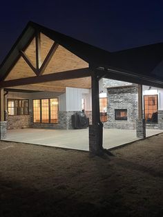 an empty building lit up at night with lights on the front and side doors open