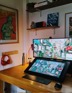 a laptop computer sitting on top of a wooden desk next to a desktop computer monitor